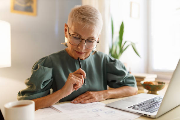 Senior couple learning together on a laptop at home